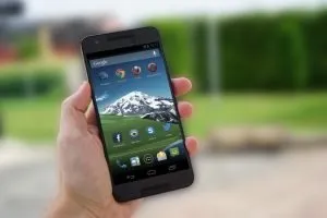 mobile phone in a person's hand, ready to research SEO predictions from Google