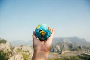 holding a globe as a representation on the importance of Global SEO vs. Local SEO