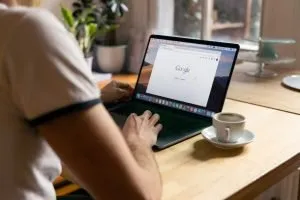 Man at a computer using Google