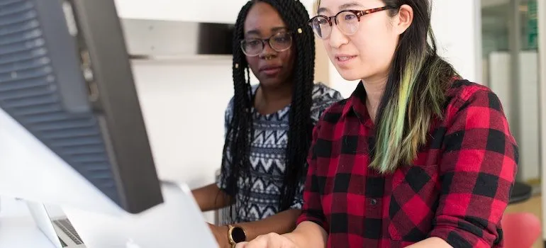 two girls using computer