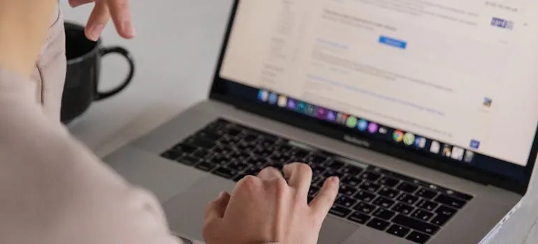 person using laptop while trying to compare competitors in Google Ads