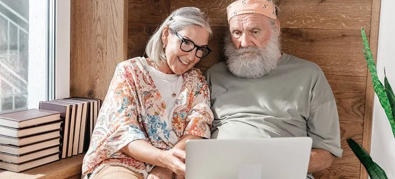 elderly couple using computer