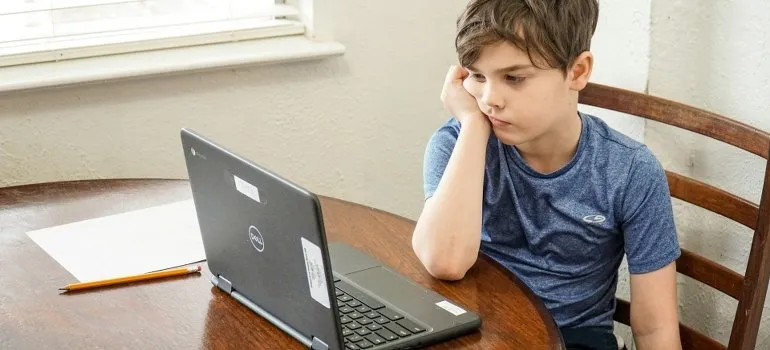 sad boy using laptop